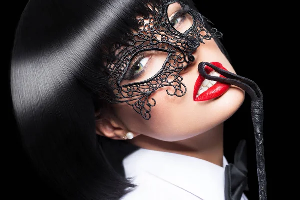 Sexy woman in mask, whip on red lips, bdsm — Stock Photo, Image