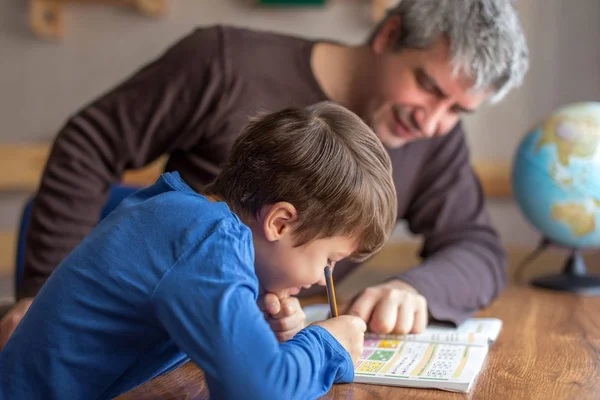 Young little shoolboy solving mathematics homework with father — Stock Photo, Image