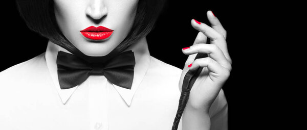 Sexy dominatrix in wig and with whip close seup banner, selective c
