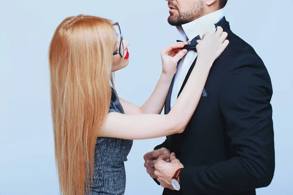 Young woman tying bow tie for stylish man