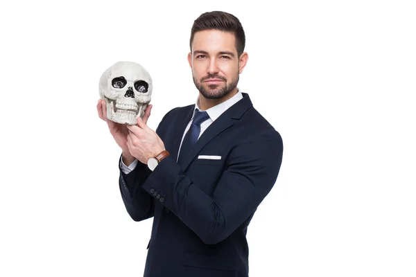 Young confident businessman holding skull isolated — Stock Photo, Image