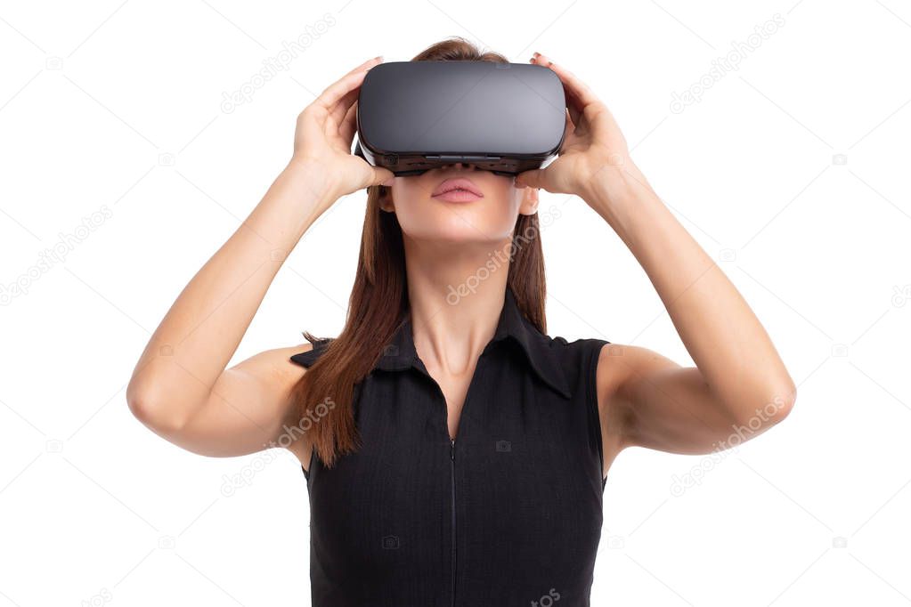 Young woman using and holding VR headset on head, isolated