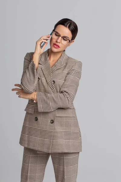 Professional businesswoman in formal wear calling
