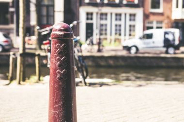 Old pillar with Amsterdam symbols clipart