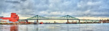 Panorama of Jacques Cartier Bridge crossing the Saint Lawrence River in Montreal, Canada clipart