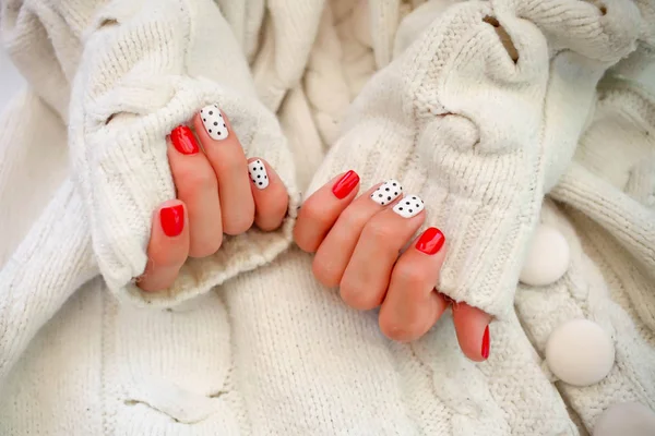 Natural nails, gel polish.Beautiful hands with manicure in a white sweater