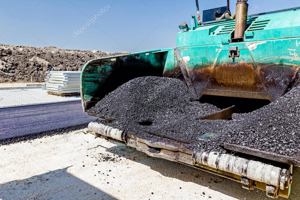 Front end of tarmac road laying machine. Asphalt spreader