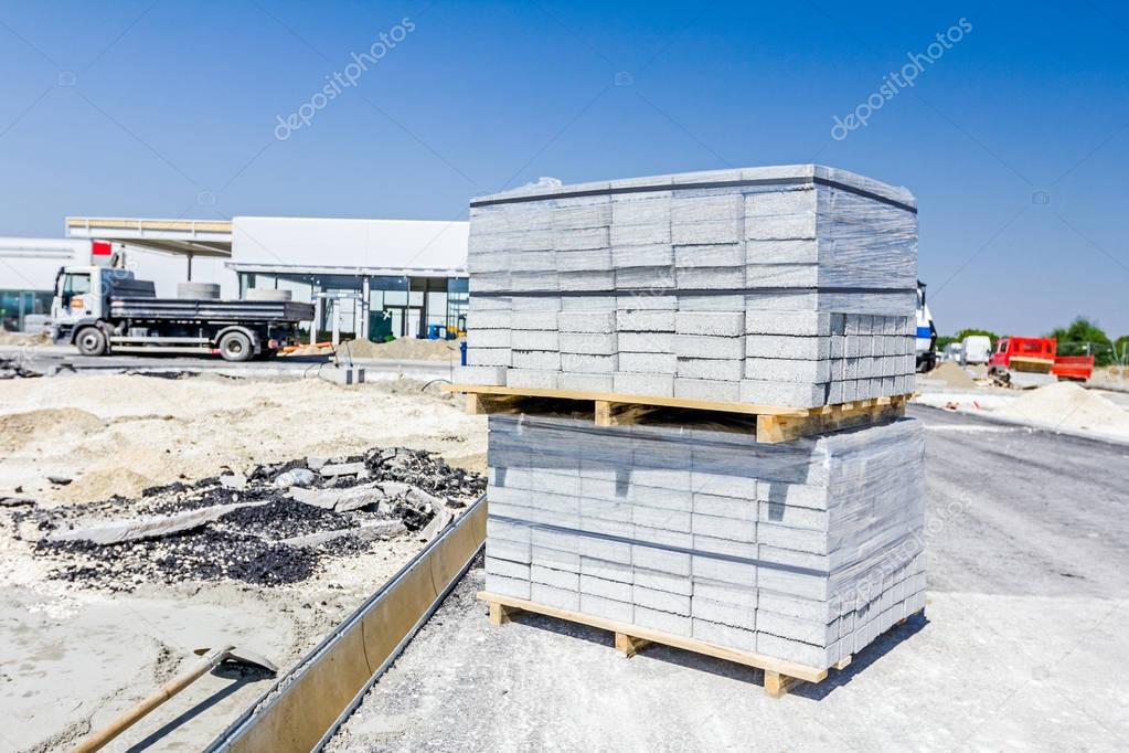 Stack of paving slabs piled on wooden pallets