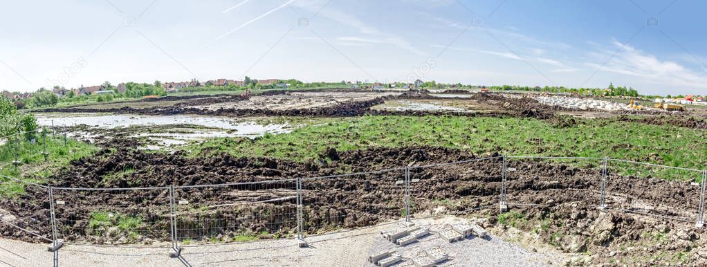 Panorama view on the construction site above the fence wire