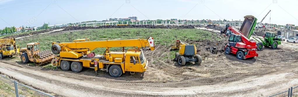 Panoramic view on the group of construction machinery who are pa