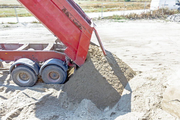 Dump truck is unloading sand