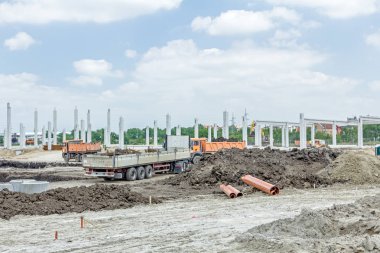 Şantiye makineleri ile bitmemiş modern edif göster