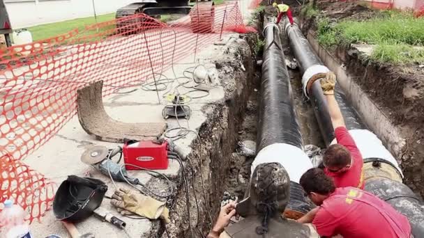 Vista em equipe de trabalhadores até a montagem de um novo gasoduto — Vídeo de Stock
