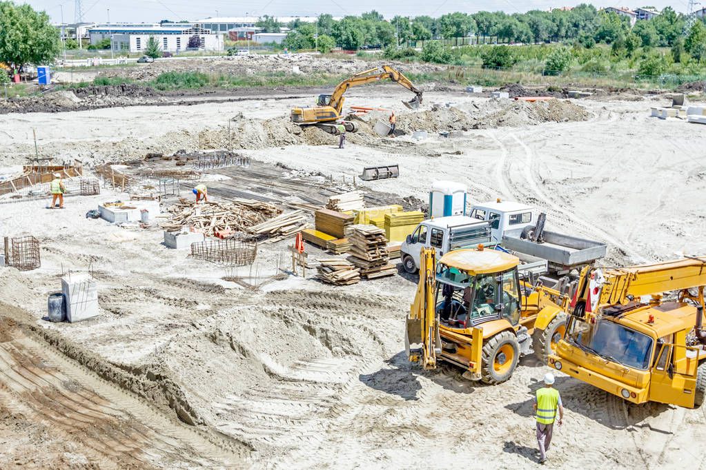 Crane, trucks are parked at building site