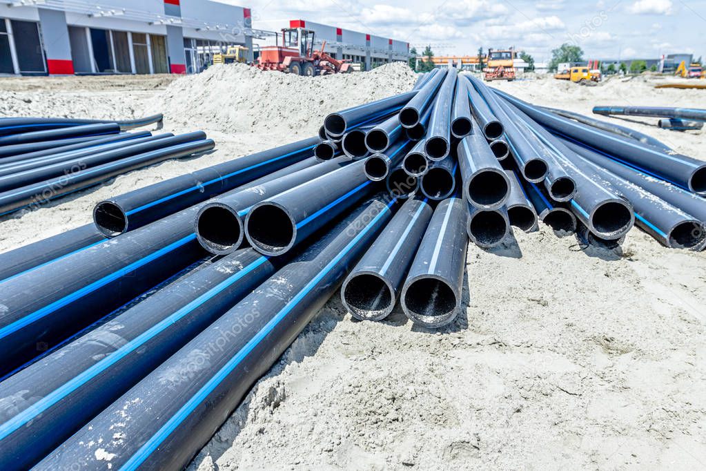 Distributed plastic pipes are stacked, piled temporarily at buil