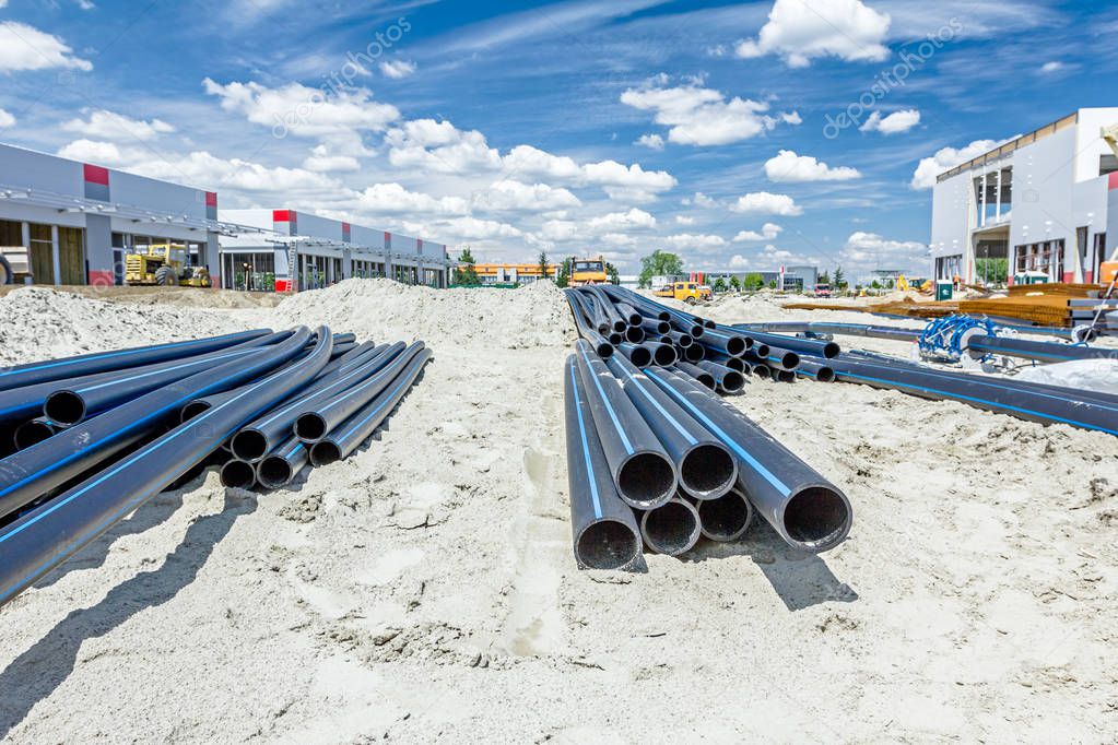 Distributed plastic pipes are stacked, piled temporarily at buil