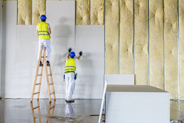 Riggers are working on thermal partition dry wall with mineral w — Stock Photo, Image