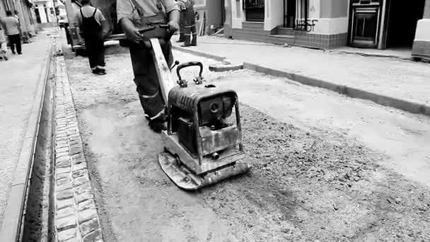 Vibrating machine is compacting soil at the construction site. — Stock Video