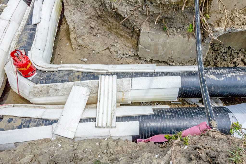 Placing set of Styrofoam thermal insulation on new pipeline in t