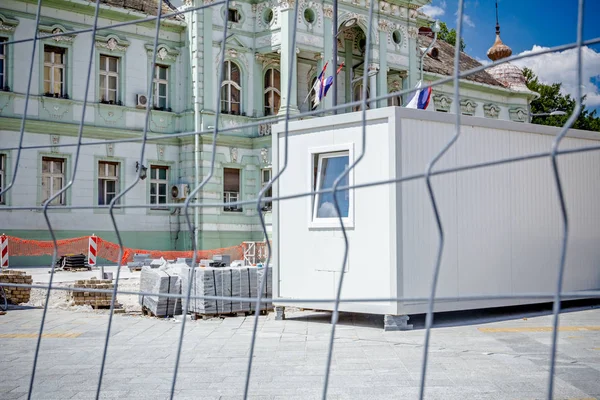 Container office at building site fenced with construction wire — Stock Photo, Image