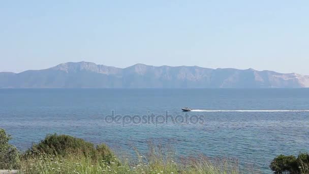 Small jetty boat is crossing over calm sea. — Stock Video