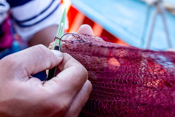 Fisherman is fixing the fish net