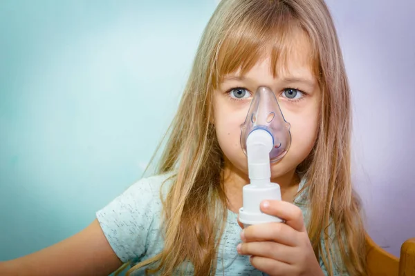 Portrait of sweet little girl using an inhaler — Stock Photo, Image