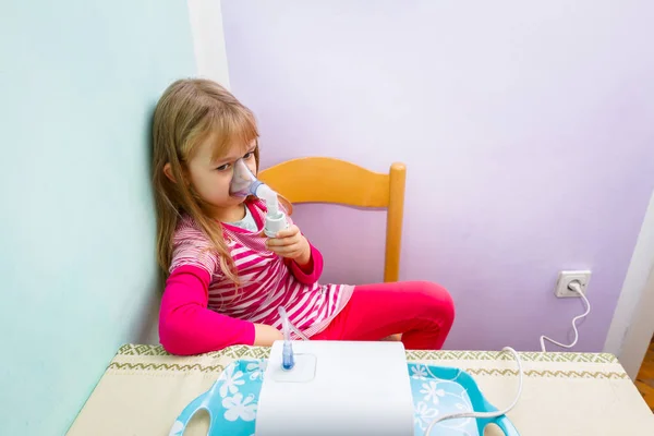 Portrait of sweet little girl using an inhaler — Stock Photo, Image