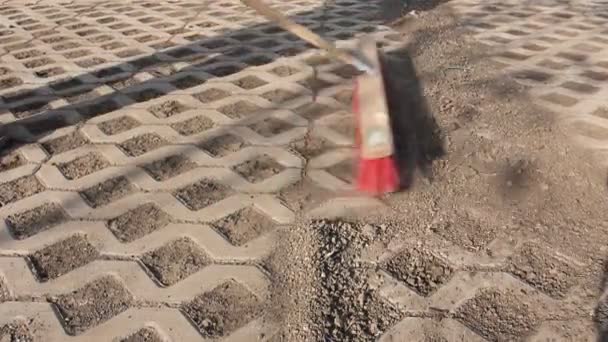 Worker Cleaning Modern Cobblestone Red Broom Worker Sweeps Dry Filth — Stock Video