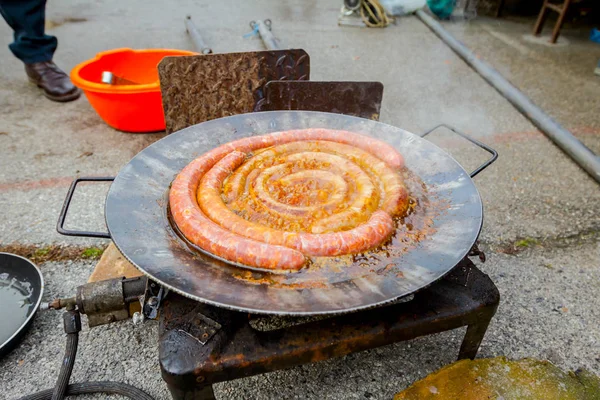 Assar deliciosas salsichas suculentas no prato de churrasco — Fotografia de Stock