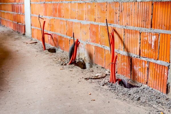 Bunch of corrugated pipes are coming out from the floor — Stock Photo, Image