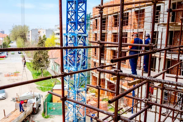 Workers are watching construction site from above, standing on s — Stock Photo, Image