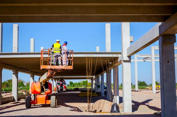 Trabalhador está gerenciando um catador de cerejeiras elevado no local de construção — Fotografia de Stock