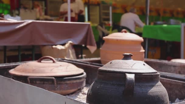 在大瓷壶里烹调 大量的食物是用一个大瓷壶 炉膛上的粘土罐烹调 — 图库视频影像