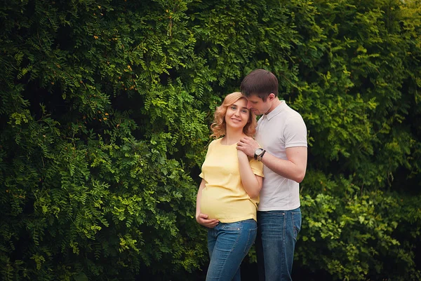 美丽的孕妇和她英俊的丈夫 抱着肚子的形象 — 图库照片