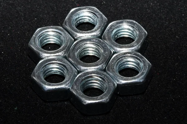 metal nuts on a black background