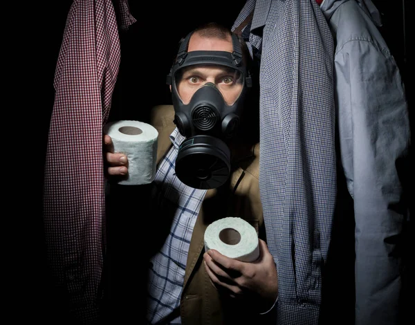 Middle-aged man hiding in a closet in connection with the COVID-19 pandemic and self-isolation. — Stock Photo, Image