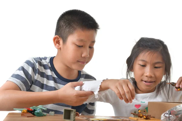 Asian boy and girl playing lego on white background. — Stock Photo, Image