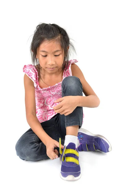 Happy Young girl wearing sport shoes on white background. — Stock Photo, Image