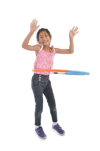 Portrait of happy little Asian child girl playing hulahoop on is — Stock Photo, Image