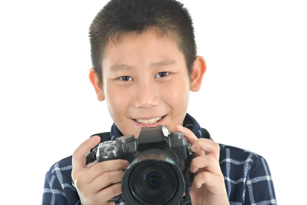 Asian boy holding camera on white background. — Stock Photo, Image