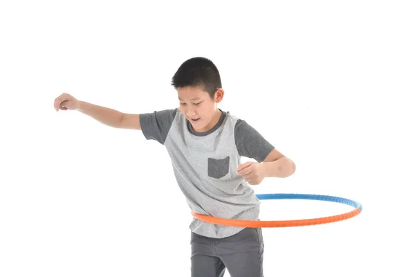 Asian boy playing with the hulahoop on a white background — Stock Photo, Image