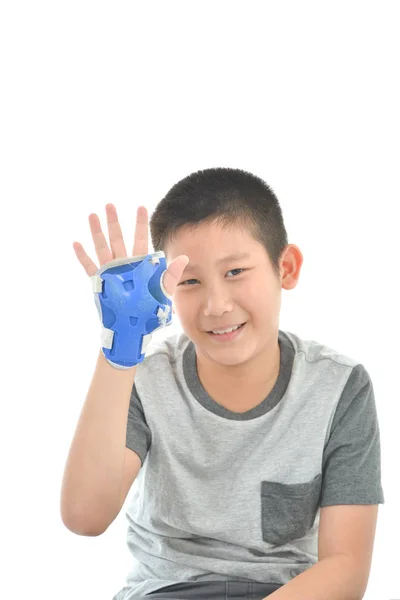 Happy Asian boy wearinghand guard for playing roller blades on w — Stock Photo, Image