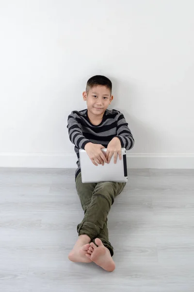 Pojken tittar på Touchpad hemma — Stockfoto