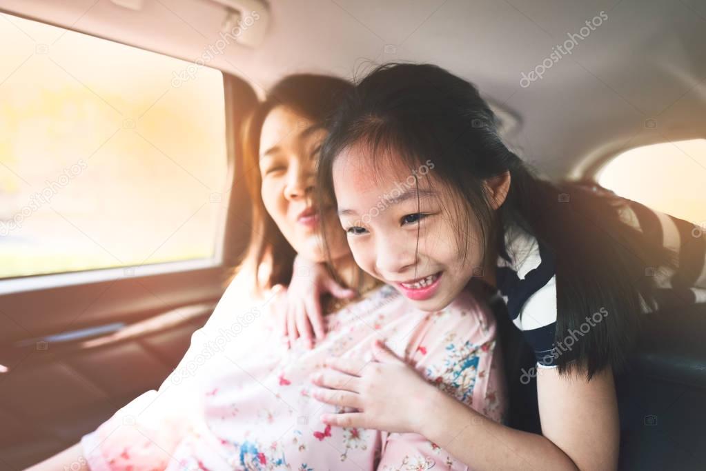 Happy kid and mother  travelling in car.