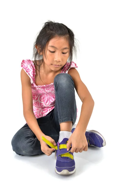 Happy Young girl wearing sport shoes on white background. — Stock Photo, Image