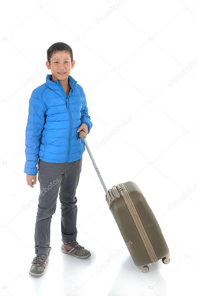 Happy Asian boy wearing blue down jacket with a suitcase. Isolat