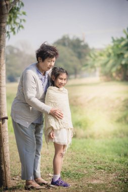 Asyalı kadın kıdemli onun torunu açık sarılma.