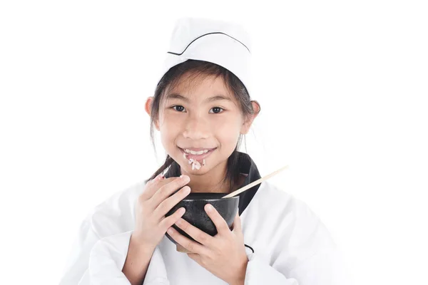 Asian young chef holding rice bowl with sticky rice on her mouth — Stock Photo, Image