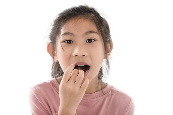 Happy Asian girl eating chocolate cornflakes isolated on white. — Stock Photo, Image